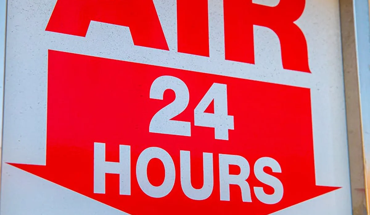 Close-up of a red and white sign reading 'AIR 24 HOURS'