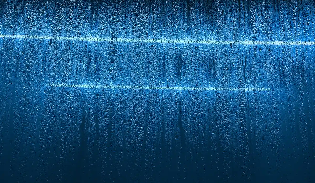 Abstract blue water background with light streaks, suitable as a backdrop for peaceful community aquarium articles.