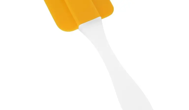 Close-up of white silicone sealant being dispensed from a yellow caulk gun nozzle