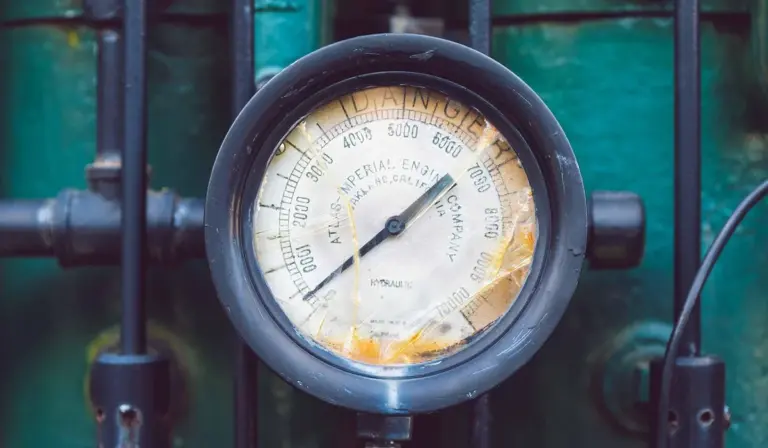 Close-up of a round analog gauge on aquarium equipment