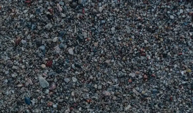 Close-up view of small aquarium gravel, illustrating the substrate used in freshwater tanks.