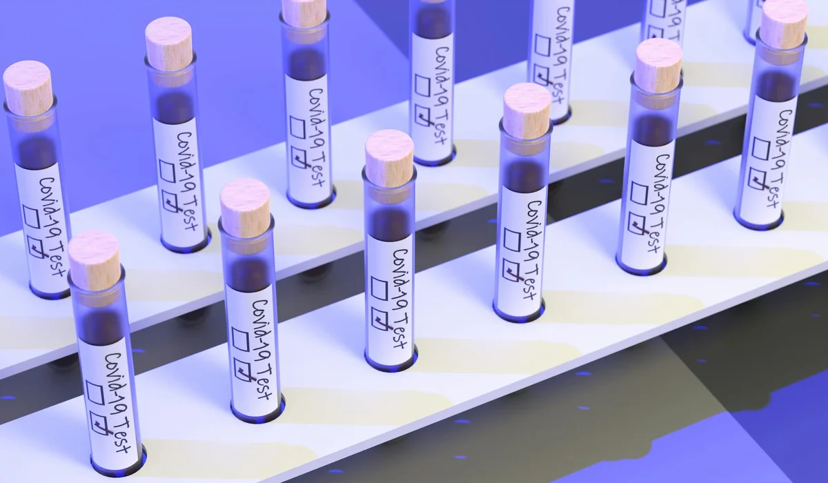 Test tubes filled with colored water labeled GH and KH tests arranged on a white rack, illustrating water hardness testing for aquariums.