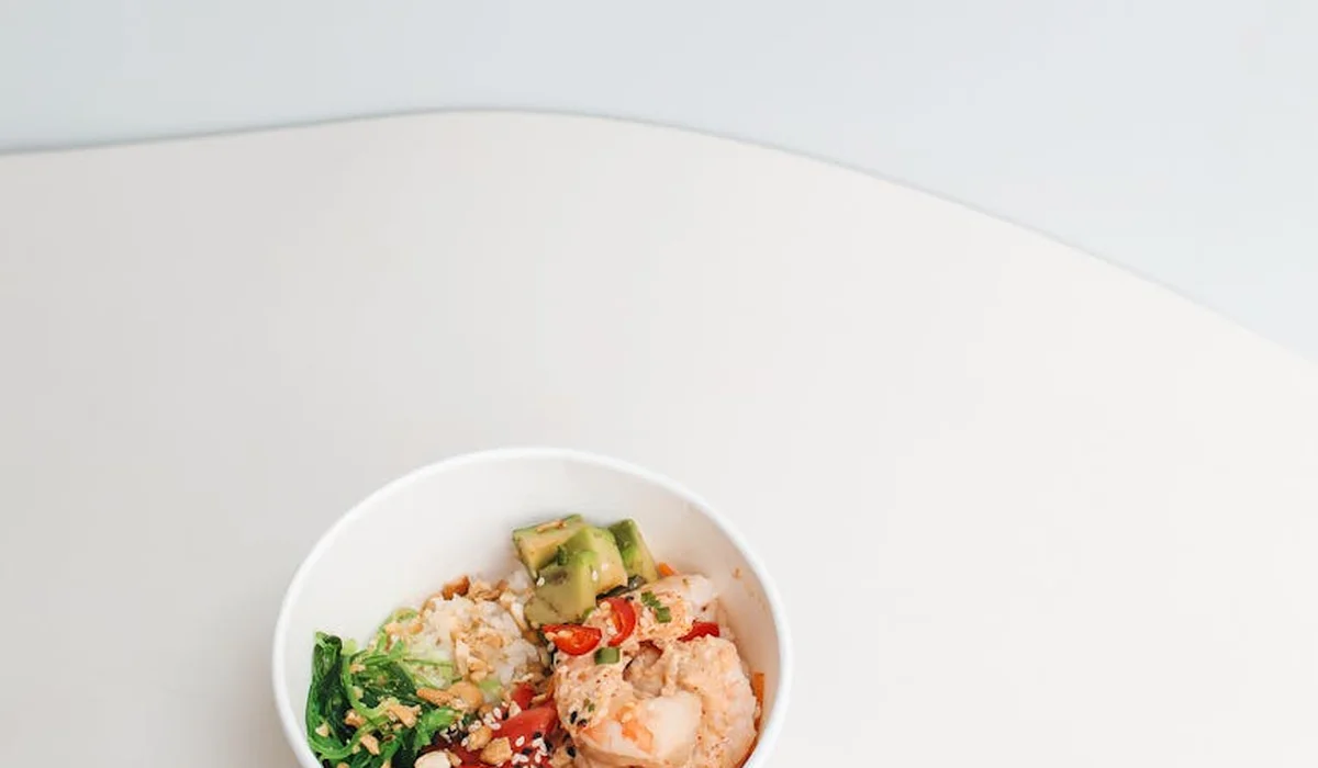 Close-up of a small white bowl with chopped ingredients, illustrating a DIY starter for growing simple live foods for aquarium fish.