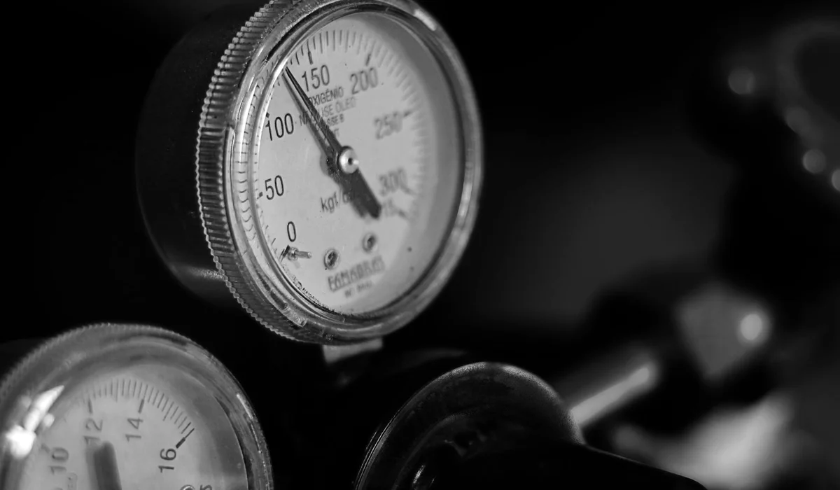 Close-up of pressure gauges on equipment in black and white